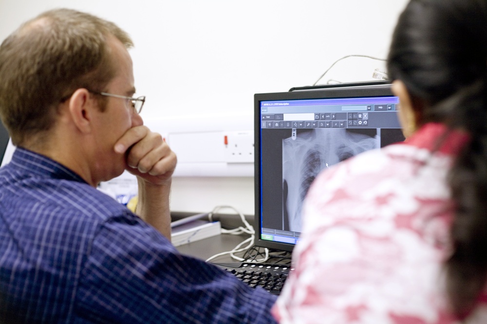 X Ray & CT Scan Man Looking At X Ray (1)